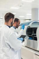 Scientists working with modern equipment in laboratory photo