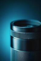 Close up of a camera lens featuring detailed markings and a sleek design under dramatic blue lighting photo