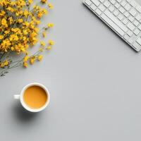 Cozy workspace with yellow flowers and a cup of coffee on a light background photo