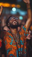 Joyful man celebrates at live concert with raised hands amidst enthusiastic crowd photo