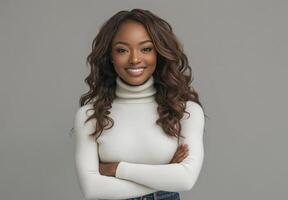 Confident woman posing with crossed arms in cozy turtleneck sweater against neutral background photo