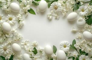 White eggs surrounded by white flowers and greenery in a decorative arrangement for spring celebrations photo