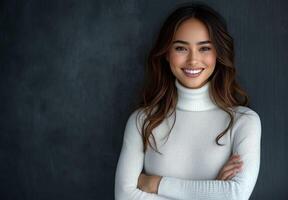 Smiling woman in cozy sweater poses confidently against a dark background photo