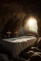 Light entering a cave with a bed and crosses in a serene setting at sunrise photo