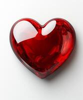 Bright red heart shaped crystal object on a white background for decorative purposes photo