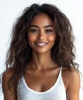 Smiling young woman with long curly hair poses in a bright indoor setting photo