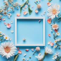 Colorful floral arrangement with empty frame on blue background during a bright day photo