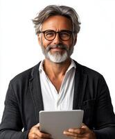 Mature man with gray hair and glasses holding a tablet and smiling against a light background photo