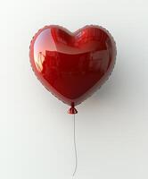 Heart-shaped red balloon floating against a light background photo