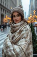 Young woman wrapped in a blanket enjoying a chilly city afternoon filled with festive lights photo