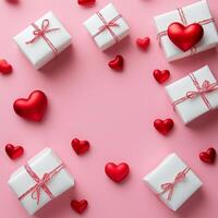Gift boxes and red hearts arranged on a pink background for a special occasion celebration photo