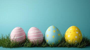 Colorful Easter eggs arranged on green grass with a vibrant blue background in spring photo