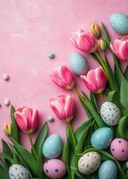 Colorful spring flowers and decorated eggs on a pink background for Easter celebration photo