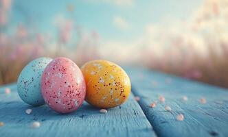 Colorful easter eggs resting on a blue wooden surface in a sunny outdoor setting photo
