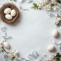 Elegant display of eggs surrounded by spring flowers and ribbons on a soft background photo