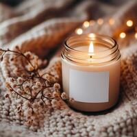 Cozy ambiance created by a lit candle surrounded by soft fabric and decorative elements in warm light photo