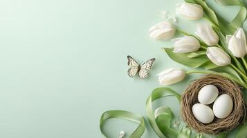 Elegant spring arrangement with tulips, eggs, and a butterfly on a mint green background photo