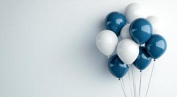 Balloons in blue and white colors arranged against a plain background for celebration photo