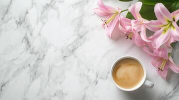 Enjoying coffee with pink lilies on a marble table in a bright setting photo