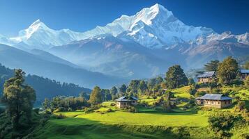 Mountain landscape with snowy peaks and traditional houses in green valley during bright daylight photo