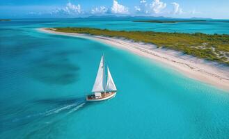 Sailing on crystal clear waters near a tropical island in the Caribbean under a bright blue sky photo