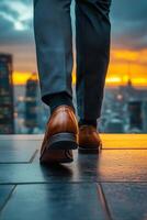 Man walks towards sunset overlooking city skyline from rooftop photo