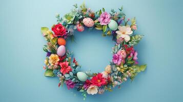 Colorful floral wreath with Easter eggs on light blue background welcomes spring season photo