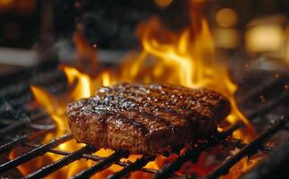 Grilling a juicy steak with flames rising in a backyard barbecue setting during evening hours photo
