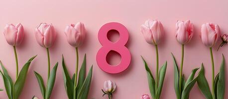 Colorful pink tulips surround a bold number eight against a soft pink background for celebration photo