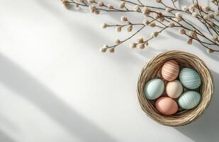 Spring celebration with pastel colored eggs in a nest and willow branches photo