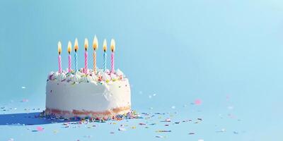 Celebrate a birthday with a colorful cake and lit candles on a blue background filled with confetti photo