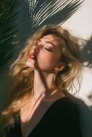 Woman with wavy hair enjoys sunlight and shadows in outdoor setting during golden hour photo