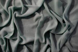 wavy crumpled Nude green fabric background texture with copy space. photo