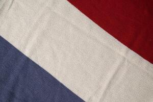 grey white milk and red on knitted fabric background texture. photo