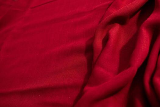 abstract background Red fabric wavy crumpled texture with copy space. photo
