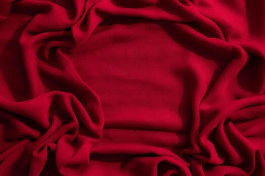 Red fabric wavy crumpled abstract background texture with copy space. photo