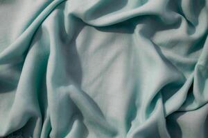 abstract background texture Nude green fabric wavy crumpled with copy space. photo