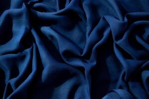Navy or dark blue fabric wavy crumpled background texture. photo