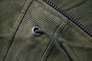 Silver ring on Green army fabric background texture. photo