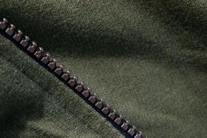 Zipper on background texture Green army jacket fabric. photo