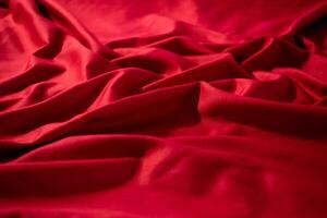 abstract background Crumpled wavy Red silky fabric texture. photo