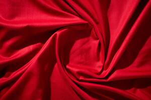 Red fabric wavy spiral crumpled texture with copy space. photo