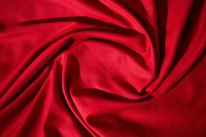 Red wavy spiral crumpled fabric texture with copy space. photo