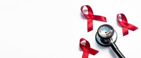 Red ribbon and stethoscope, HIV awareness, AIDS day, world cancer day isolated white background. photo