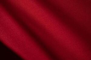 Diagonal Wavy Red fabric abstract background texture. shiny, glossy and elegant background. photo
