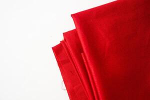 Folded Red fabric background texture on white background. photo