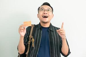 Happy asian student hold credit card with pointing gesture. Banking, Financial isolated white background photo