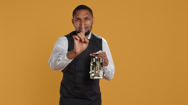 Professional waiter asking clients to wait a bit before serving them, working in a very busy restaurant. Employee trying to serve customers faster, showing professionalism in catering. Camera B. photo