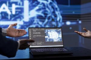Computer scientists use AI cognitive computing to extract information from complex data on laptop. Close up of IT specialists using artificial intelligence technology on notebook photo