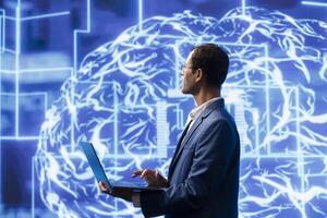 Computer scientist analyzes AI models with large digital brain displayed behind. IT specialist in workspace using machine learning to better understand and develop artificial intelligence photo